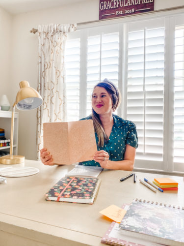 woman sitting at desk with planner